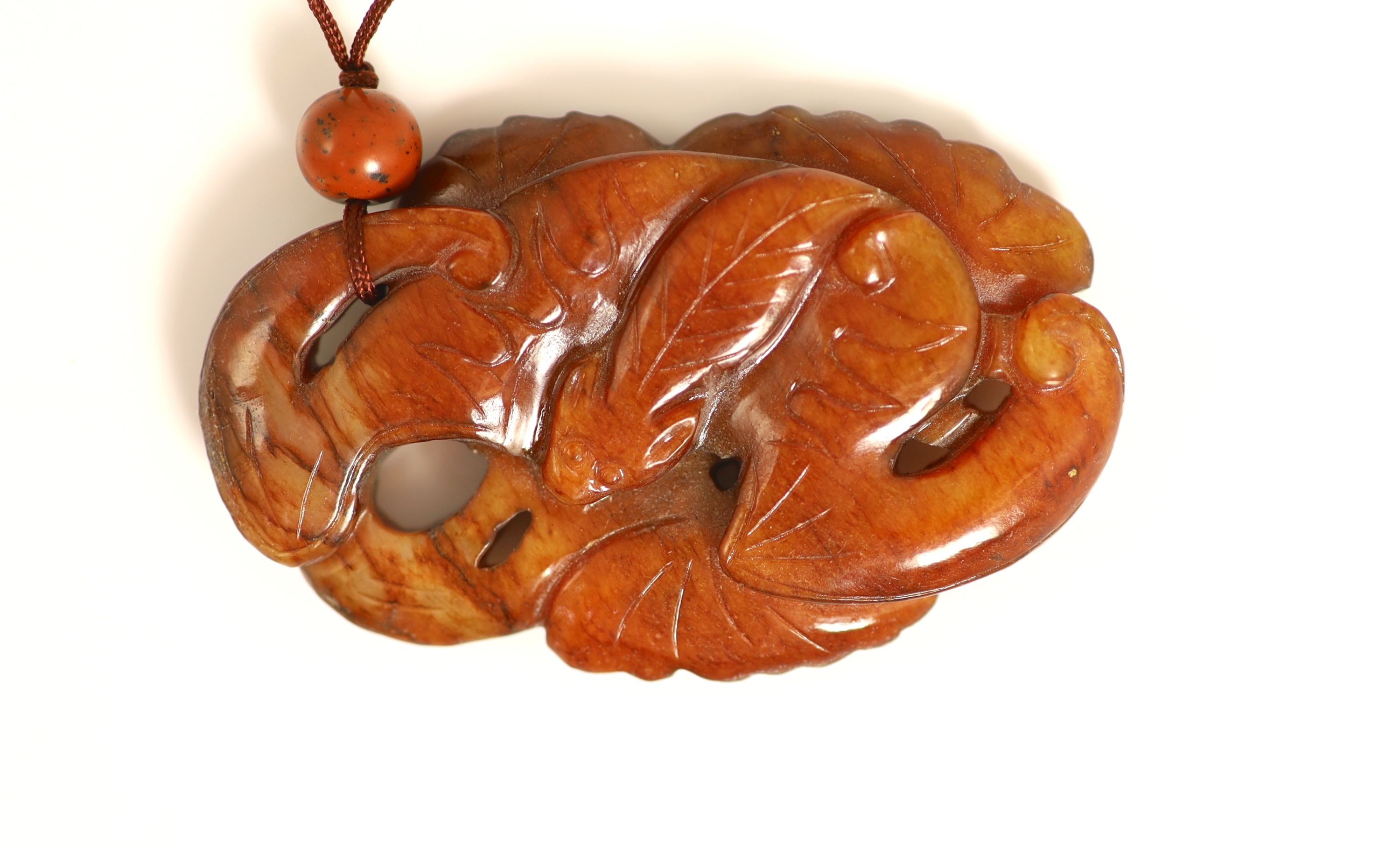 A Chinese russet jade pendant, 19th century, 7.3cm